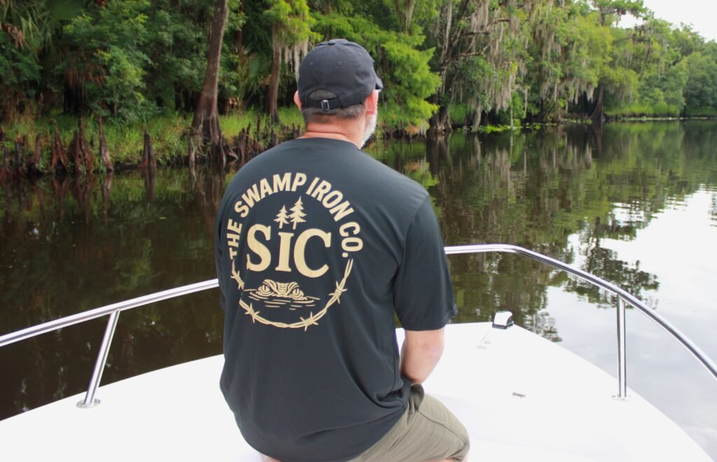 Person wearing black Built for the Grit Dri-Fit T-shirt with SIC chest logo