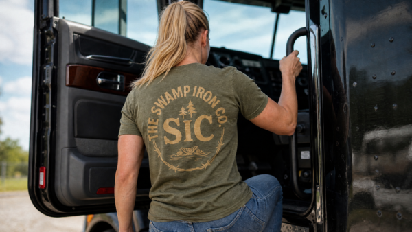 Woman wearing Military Green Built for the Grit T-Shirt with large circular SIC back logo