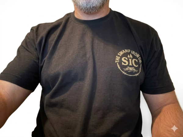 Person wearing black Built for the Grit T-Shirt with circular SIC chest logo